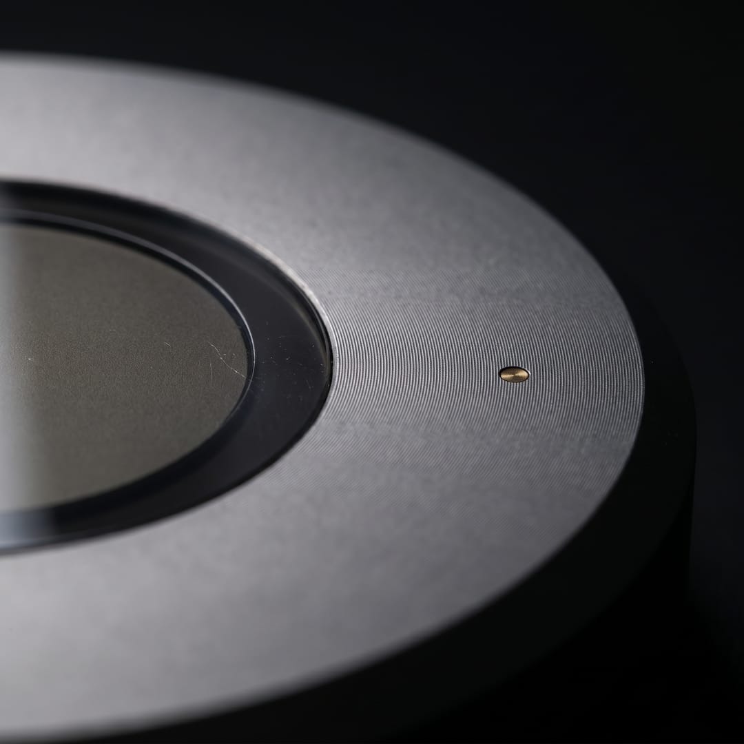 Macro detail of the smoked-glass aperture ring and machined aluminum tooling marks